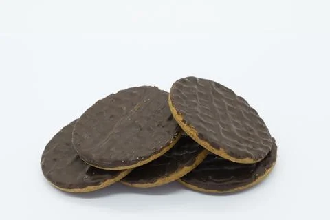Dark chocolate-coated biscuits stacked neatly 写真素材