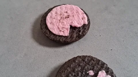 Dark chocolate cookie with pink strawberry cream motion video footage Stock Footage 339248951