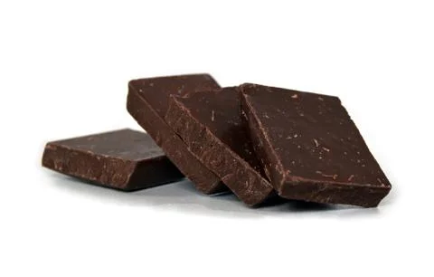 Dark chocolate cubes stack on white background Stockfoto's