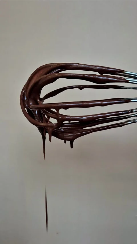 Dark chocolate drips from the whisk Stock Footage 306474556