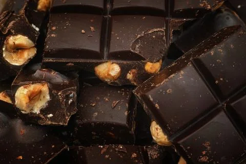 Dark chocolate with hazelnuts. Close up. Stock Photos