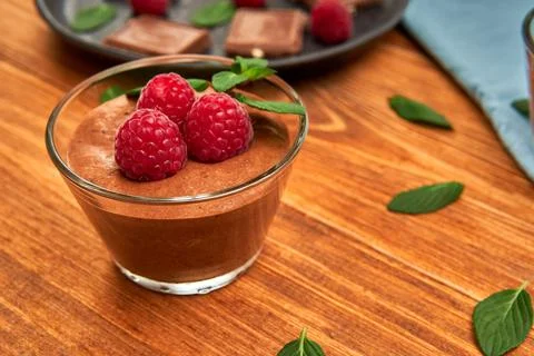 Dark Chocolate mousse homemade with raspberries and mint Stock Photos