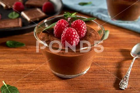 Dark Chocolate mousse homemade with raspberries and mint Stock Photos