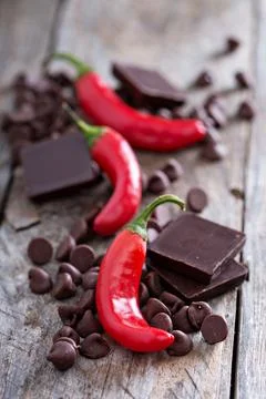 Dark chocolate pieces and chips with red hot chilli pepper Stock Photos
