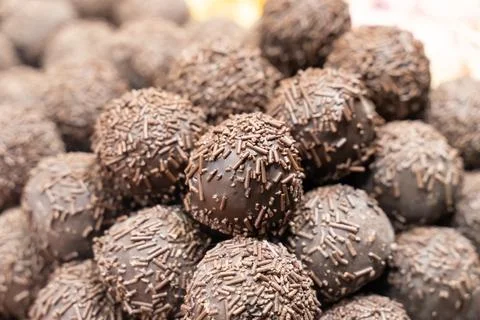 Dark chocolate pralines stacked stack close-up, pastry background Stock Photos