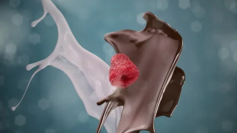 Dark chocolate raspberry and fresh milk splashing and falling with bokeh Stock Footage 253705683