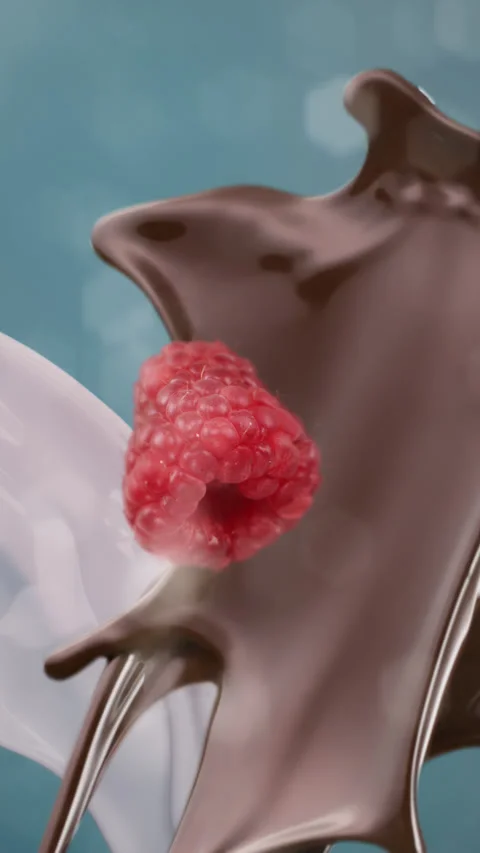 Dark chocolate raspberry and fresh milk splashing and falling in slow motion Stock Footage 255675928