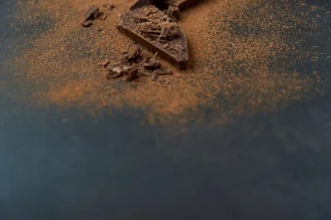Dark chocolate stack, chips and cocoa powder with coffee bean on dark background Stock Photos