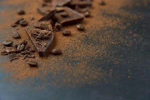 Dark chocolate stack, chips and cocoa powder with coffee bean on dark background Stock Photos