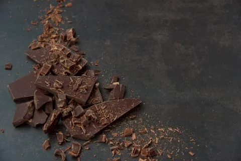 Dark chocolate stack, chips on a dark background. Confectionery and food concept Stock Photos