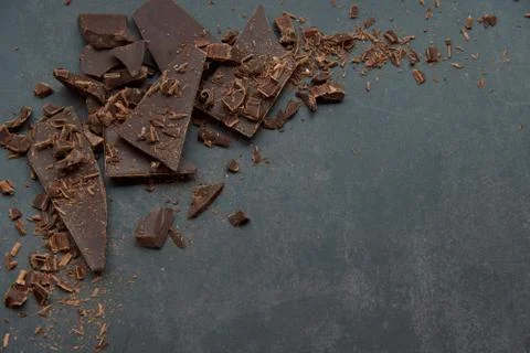 Dark chocolate stack, chips on a dark background. Confectionery and food concept Stock Photos