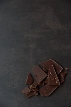 Dark chocolate stack on a dark background. Confectionery and food concept. Stock Photos