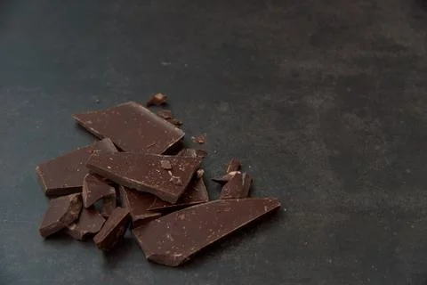 Dark chocolate stack on a dark background. Confectionery and food concept. Stock Photos