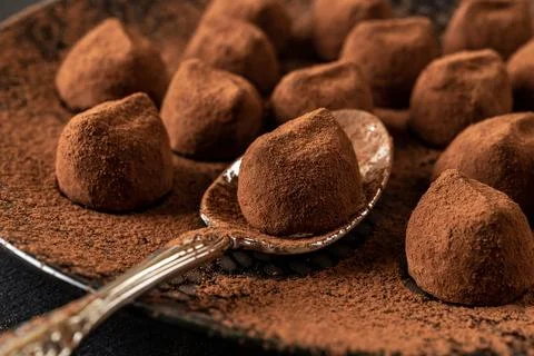 Dark chocolate truffle on a spoon macro. Stock Photos