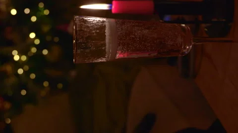 Dark Christmas background with thin red burning candles and glowing garland ligh Stock Footage 325973733