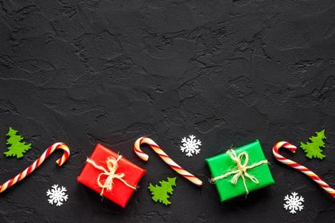Dark Christmas layout with tree branches gifts and decorations Stock Photos