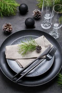Dark christmas table setting design. Black  plates, champagne glasses, Stock Photos