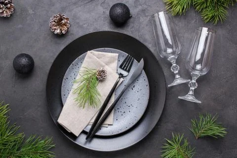 Dark christmas table setting design. Black  plates, champagne glasses, Stock Photos