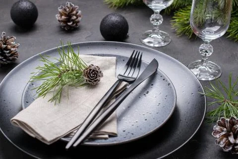 Dark christmas table setting design. Black  plates, champagne glasses, Stock Photos