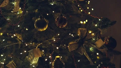Dark christmas tree decorated red ball, garland lights, white ornaments, night 動画素材 256108085