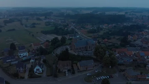 Dark cinematic flying over small town village  with church in flandersbelgium Stock Footage 123090081