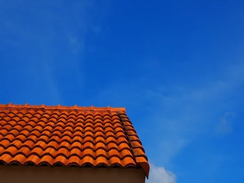 Dark clear blue sky with red roof, white small cloud moving out Stock Footage 81080265