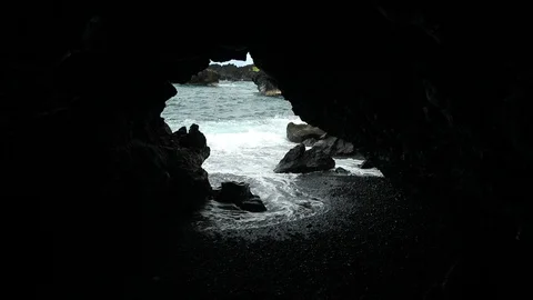 Dark Cliff opening on a Beach Stock Footage