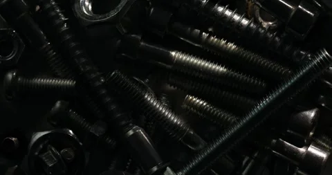 Dark Close-Up of Metallic Bolts and Nuts Stock Footage 293370274
