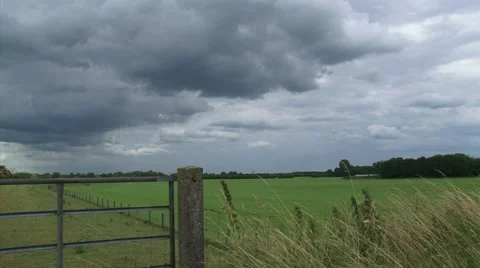 Dark cloud above Dutch rural landscape + pan dike and farmhouse in cornfield Stock Footage 40293718