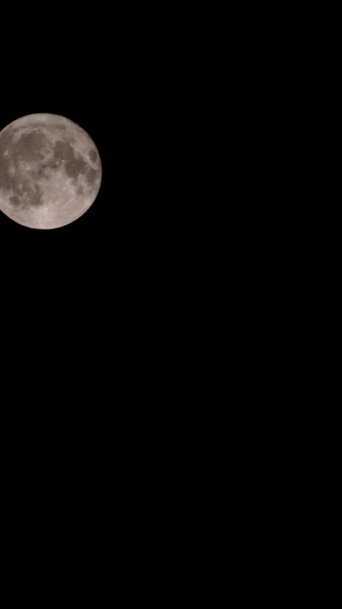 A dark cloud blocks the full moon in the sky. Stock Footage 320522094