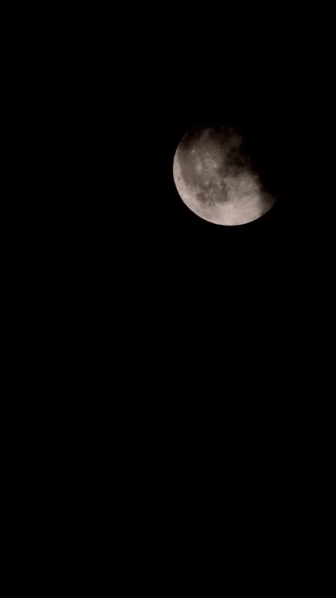 A dark cloud blocks the full moon in the sky. Stock Footage 320522096