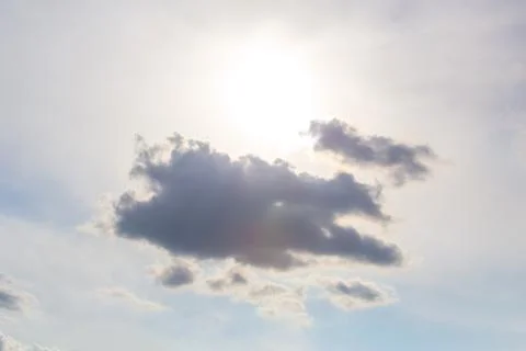 Dark cloud on  blue sky. Sun rays through gray clouds. Stock Photos