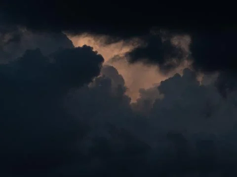 A dark cloud is creeping over the blue sky Foto stock