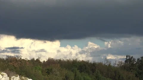 Dark cloud in front with light clouds in the background Stock Footage 159075529