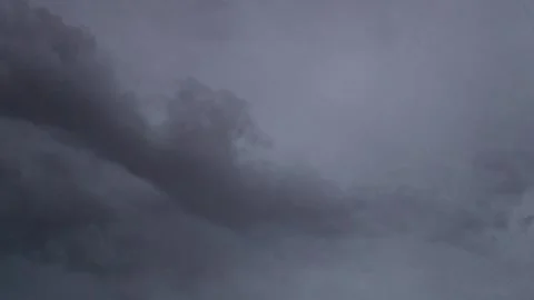 Dark Cloud Moving Across a Pale Gray Sky Stock Footage 342652851