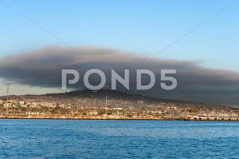Dark cloud over oceanfront land Stock Photos