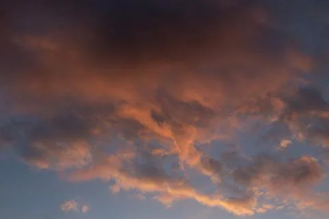 Dark cloud sky illuminated red setting sun Stock Photos