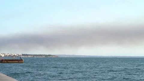 Dark cloud of smoke or smog hanging low over the city Thessaloniki  In Greece Stock Footage 337671324