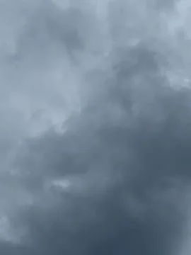 Dark Cloud Texture Against Pale Sky Stock Photos
