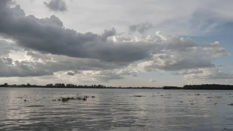 Dark clouds and blue sky over the river Stock Footage 107346089