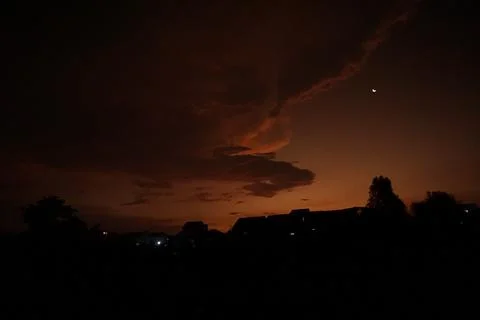 Dark clouds and the moon in the corner corner Stock Photos