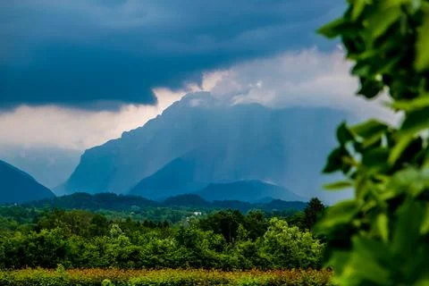 Dark clouds and rain over mountains in Dolomites, Italy Stock Photos
