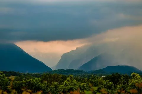 Dark clouds and rain over mountains in Dolomites, Italy Stock Photos