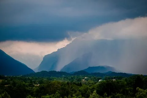 Dark clouds and rain over mountains in Dolomites, Italy Stock Photos