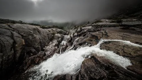 Dark clouds and a rough waterfall Stock Photos