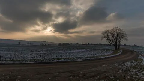 Dark clouds and sun in winter landscape 写真素材
