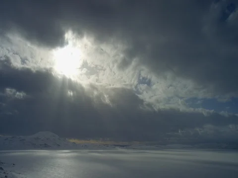 Dark clouds and sunbeam over the snow covered landscape 库存影片 73283804