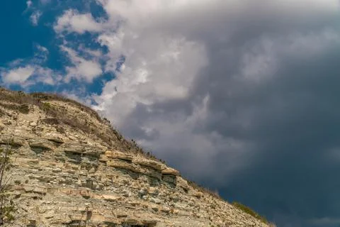 Dark clouds on the background of the high coast near Gelendzhik. Stock Photos