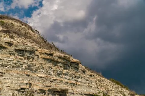 Dark clouds on the background of the high coast near Gelendzhik. Stock Photos
