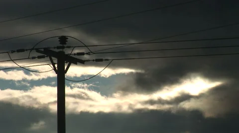 Dark clouds behind electric cables suggesting uncertain future for power 스톡 동영상 40157802